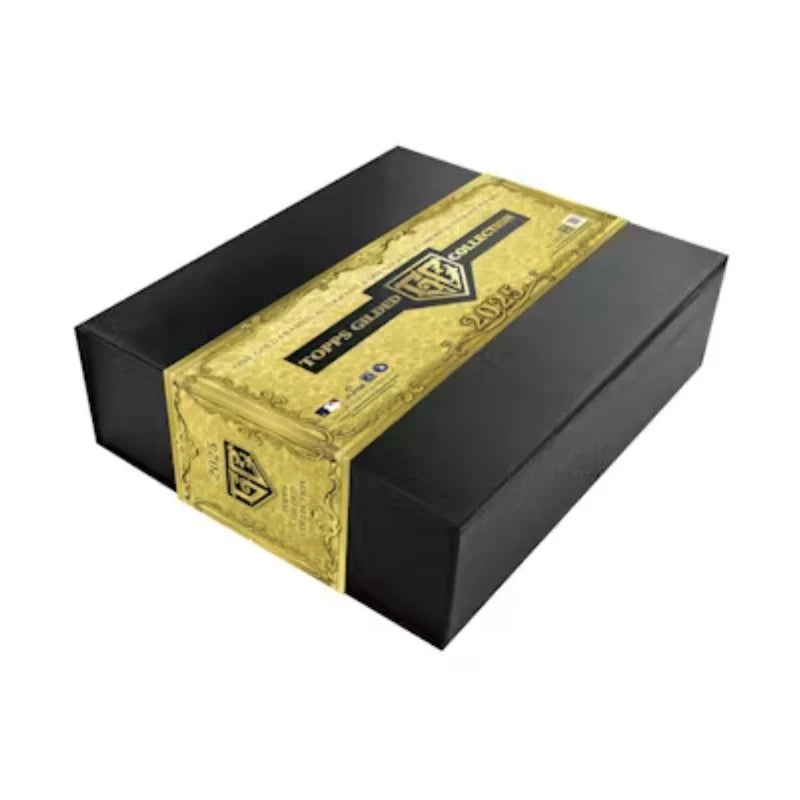 A black rectangular hobby box for the 2025 Topps Gilded Collection with a gold decorative band.
