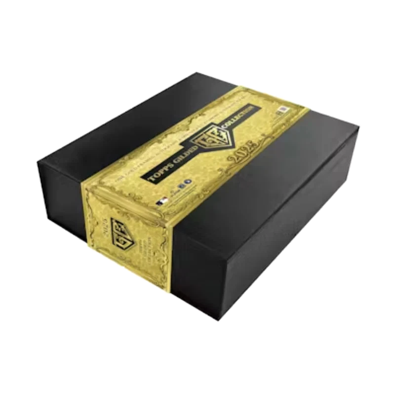 A black rectangular hobby box for the 2025 Topps Gilded Collection with a gold decorative band.