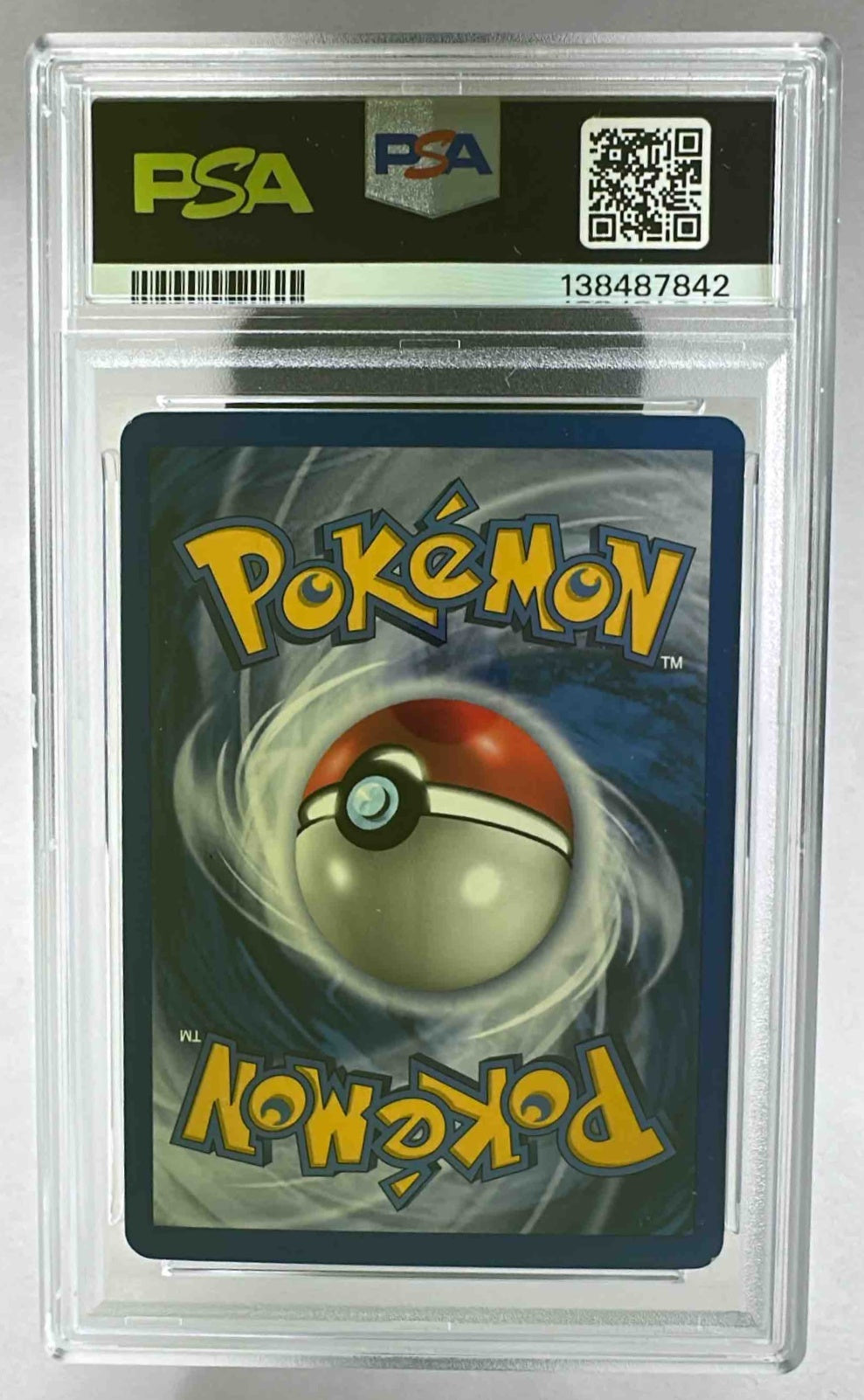 A PSA 7 graded 2002 Pokemon Legendary Collection Pokemon Trader reverse holo card in a slab.