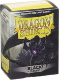 A box of 100 black Dragon Shield classic standard size card sleeves featuring a dragon illustration.