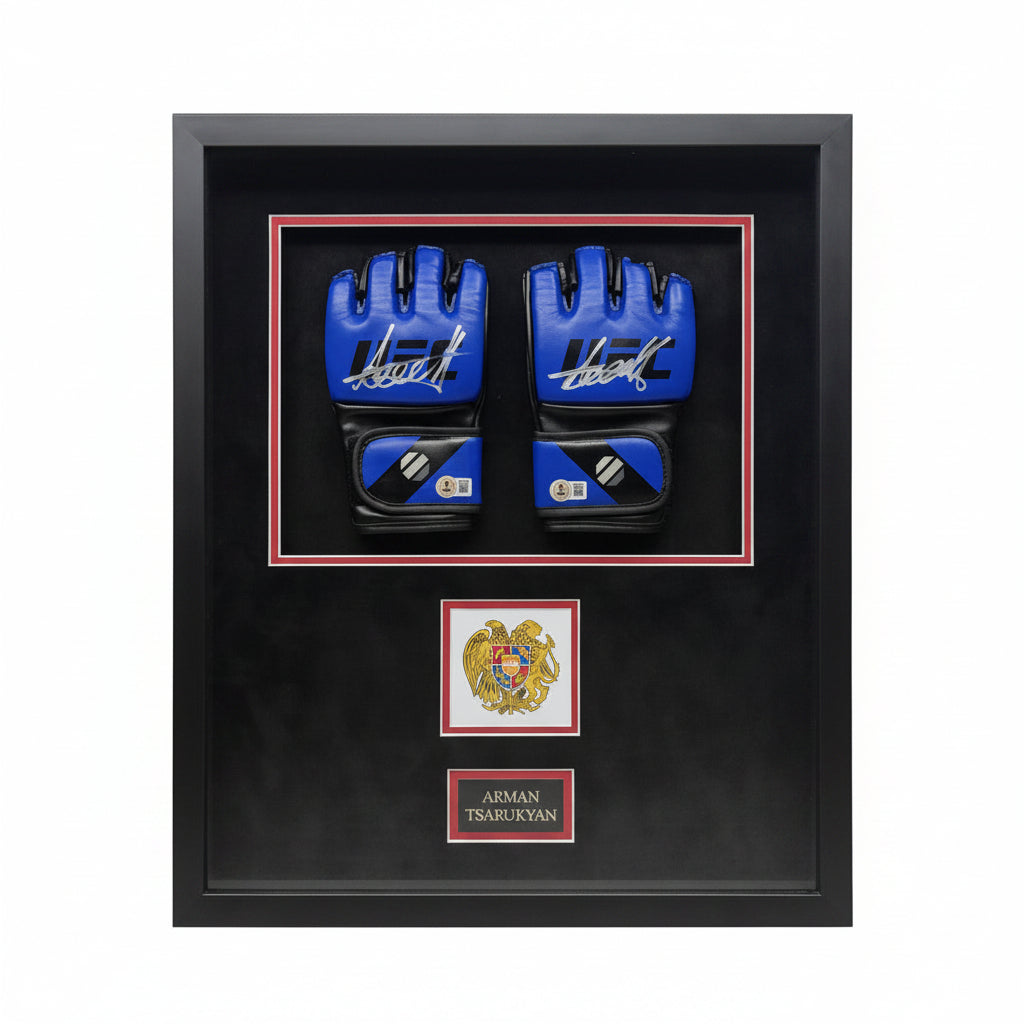 A pair of signed blue UFC gloves by Arman Tsarukyan displayed in a black frame with an emblem.