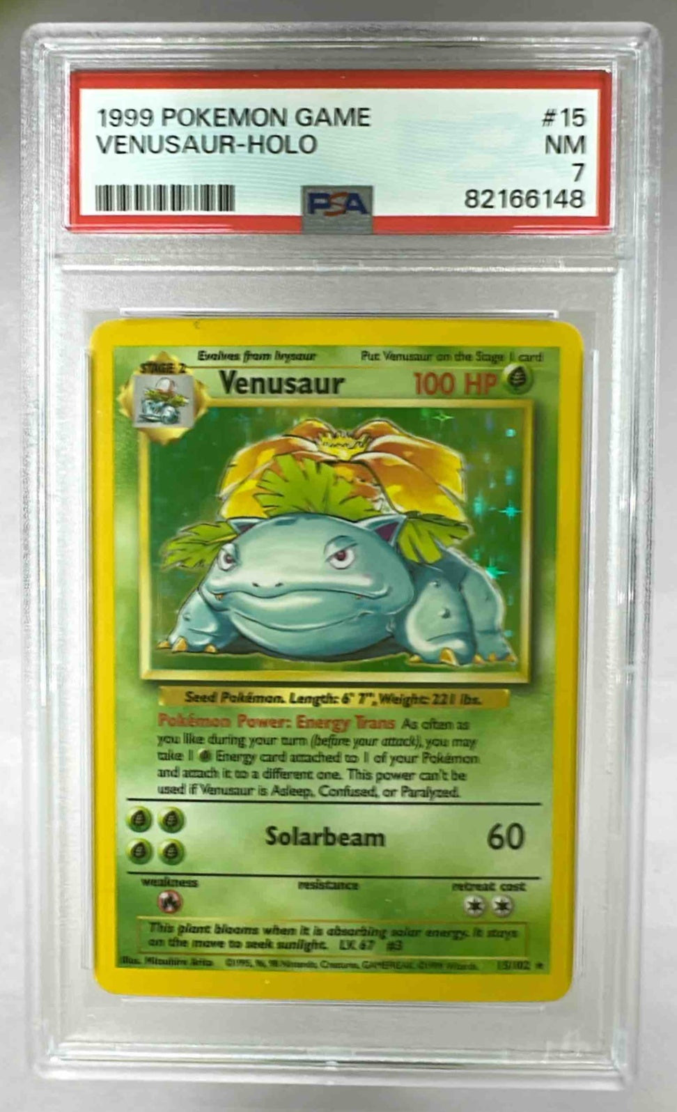 A 1999 Pokemon Venusaur holographic card graded PSA 7 in a protective plastic slab.