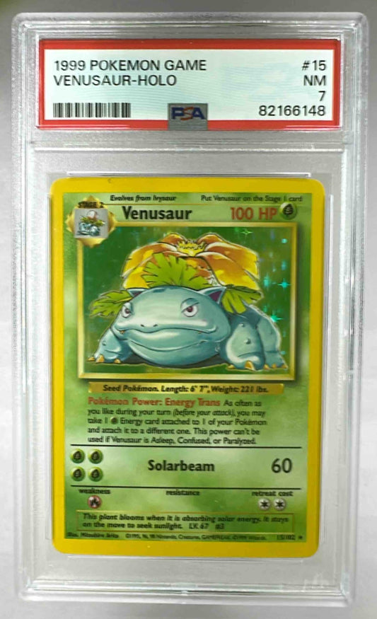 A 1999 Pokemon Venusaur holographic card graded PSA 7 in a protective plastic slab.