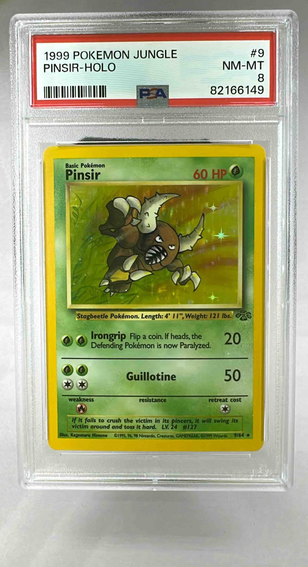A PSA 8 graded 1999 Pokemon Jungle Pinsir holographic trading card in a protective plastic slab.