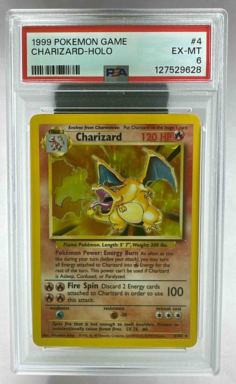 A PSA 6 graded 1999 Shadowless Charizard holographic Pokemon card in a protective plastic slab.