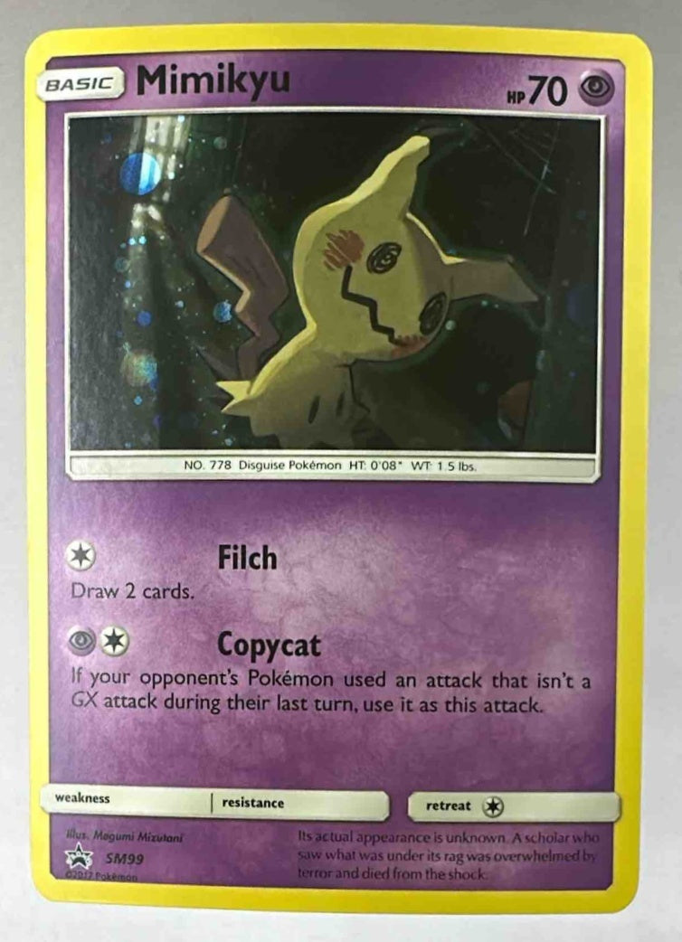 A Mimikyu Pokemon trading card from the SM99 Black Star Promos set with a holographic finish.